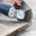 Angle grinder cutting concrete